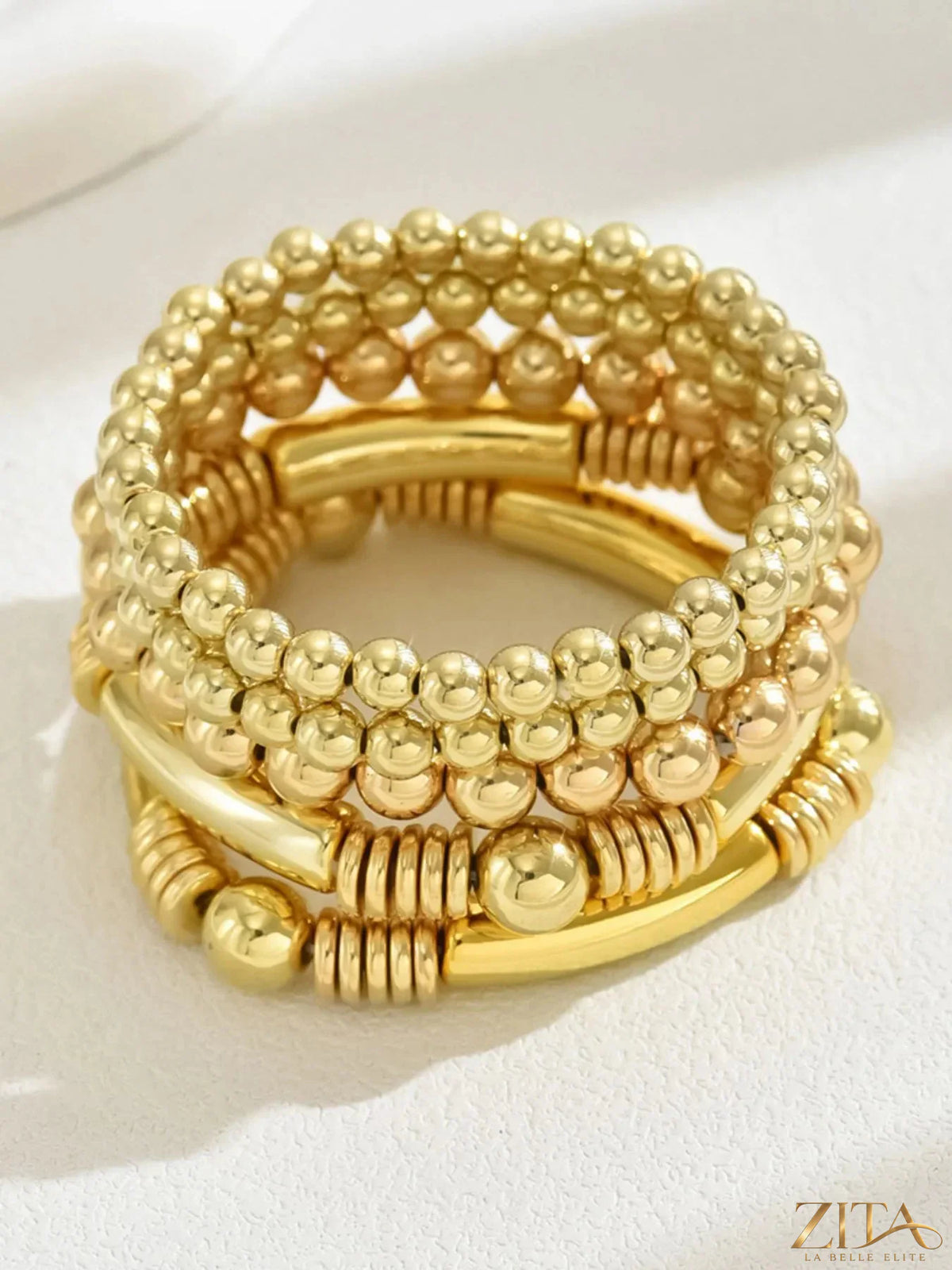 Five colorful plastic beaded bracelets from Zita La Belle Elite, arranged in a row on a neutral background.