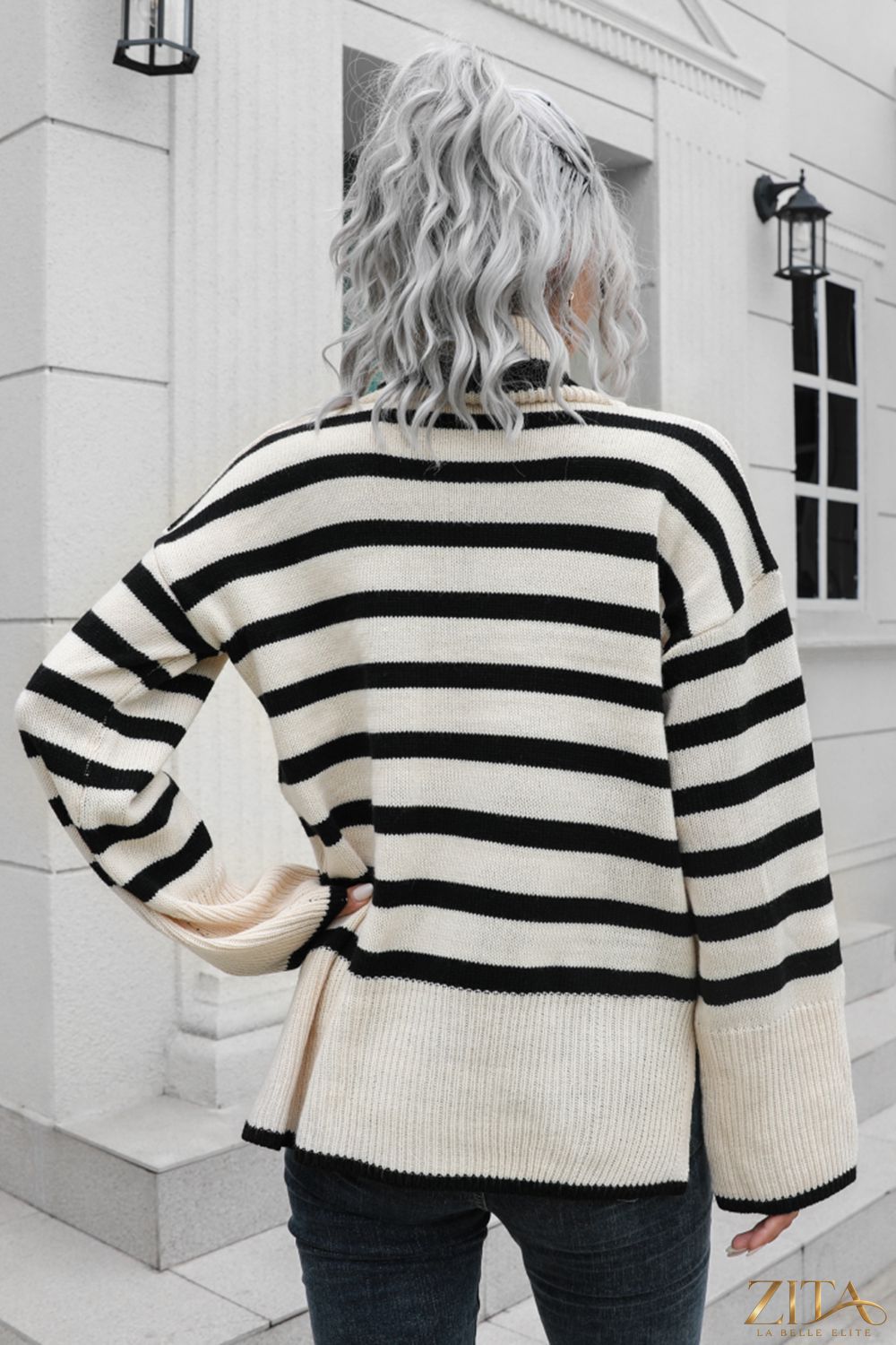 Striped turtleneck drop shoulder sweater by Trendsi, featuring a cozy knit design with bold horizontal stripes in various colors.