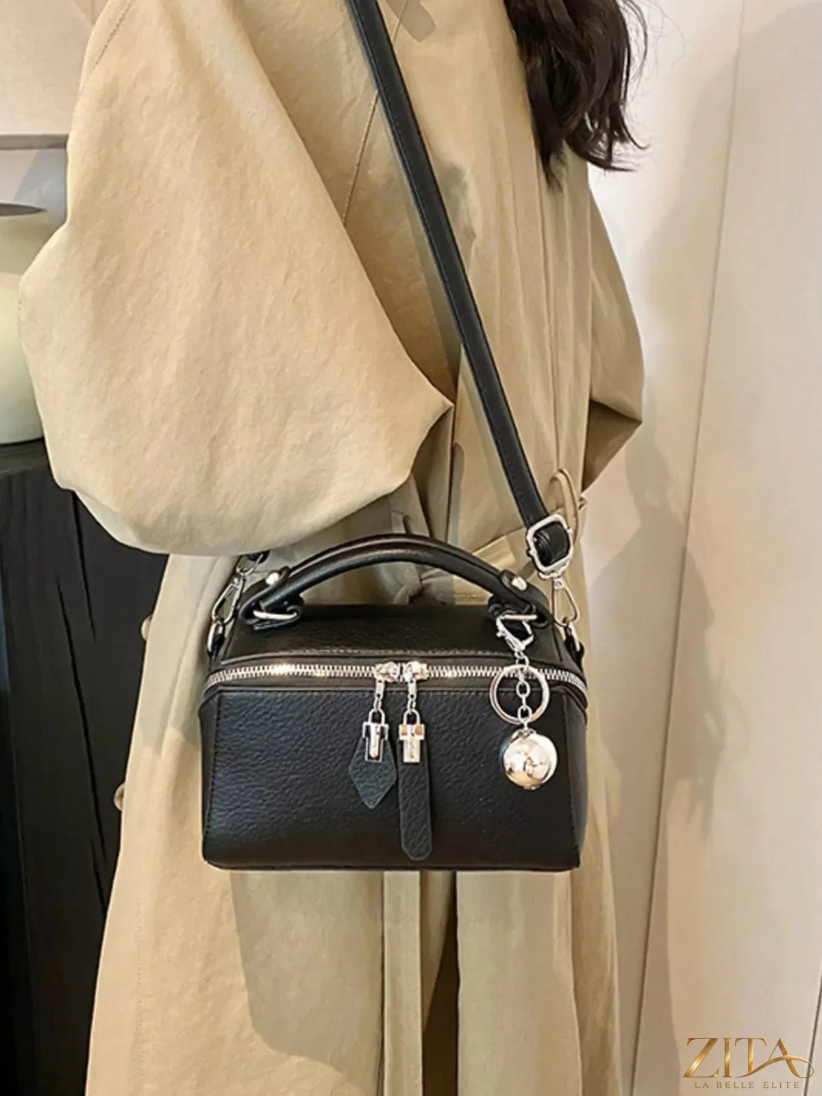 Textured leather handbag by Trendsi featuring a structured design, top handle, and subtle stitching details.