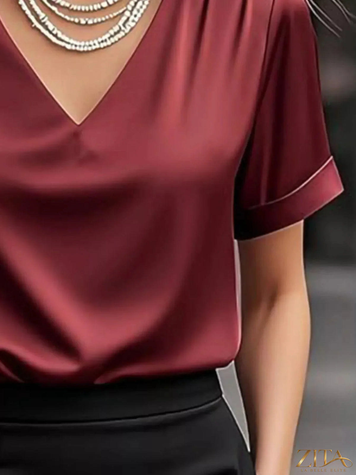 Zita La Belle Elite satin V-neck short sleeve blouse in elegant fabric, showcasing smooth texture and sleek design.