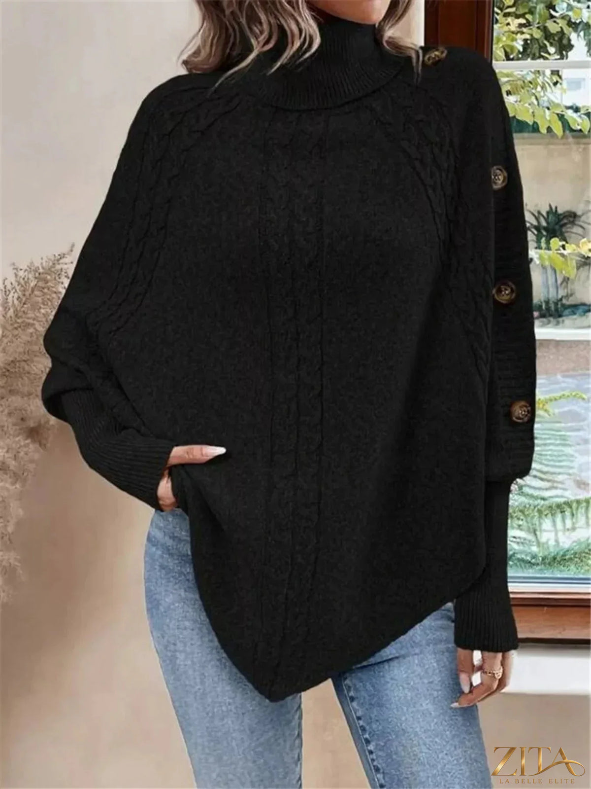 Cable knit turtleneck cape sweater from Trendsi, featuring a cozy, textured design with a high neckline and flowing silhouette.