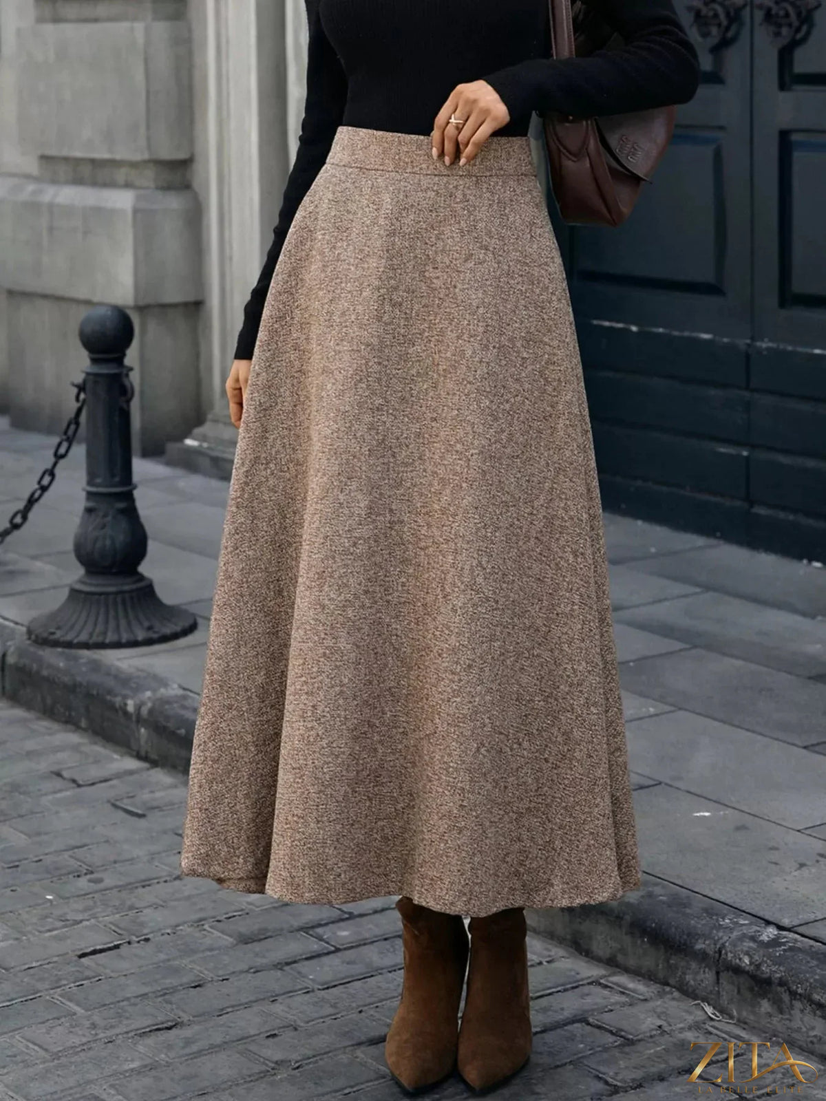 A-line midi skirt from Trendsi featuring a flowy, knee-length design in a neutral fabric, perfect for casual or dressy outfits.
