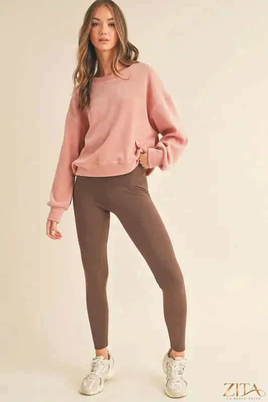 Black fleece-lined high-waisted leggings by Yelete, full size, Trendi brand, shown on a model with a close-up of the fabric and waist fit.