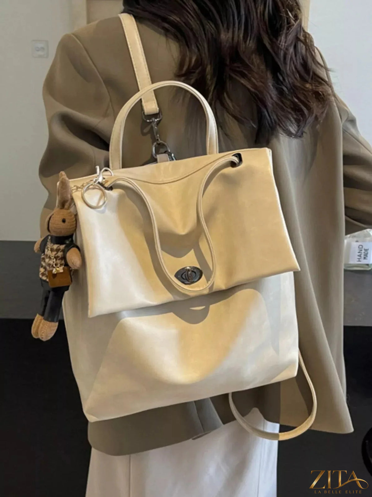 Leather flap backpack bag by Trendsi, showing a stylish brown leather bag with flap closure and adjustable straps.