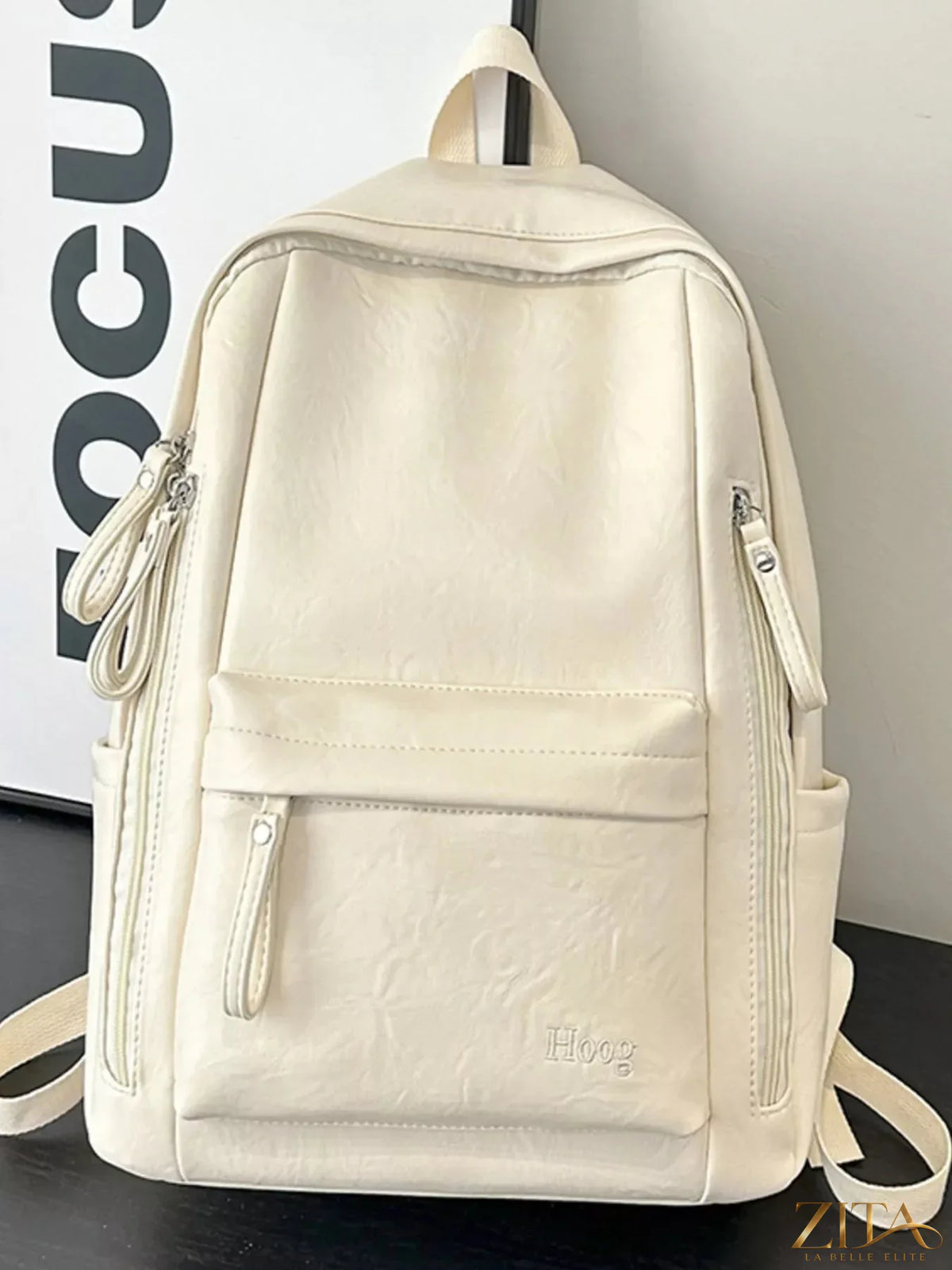 Leather texture backpack bag with adjustable straps and zippered compartments, designed for stylish everyday use.