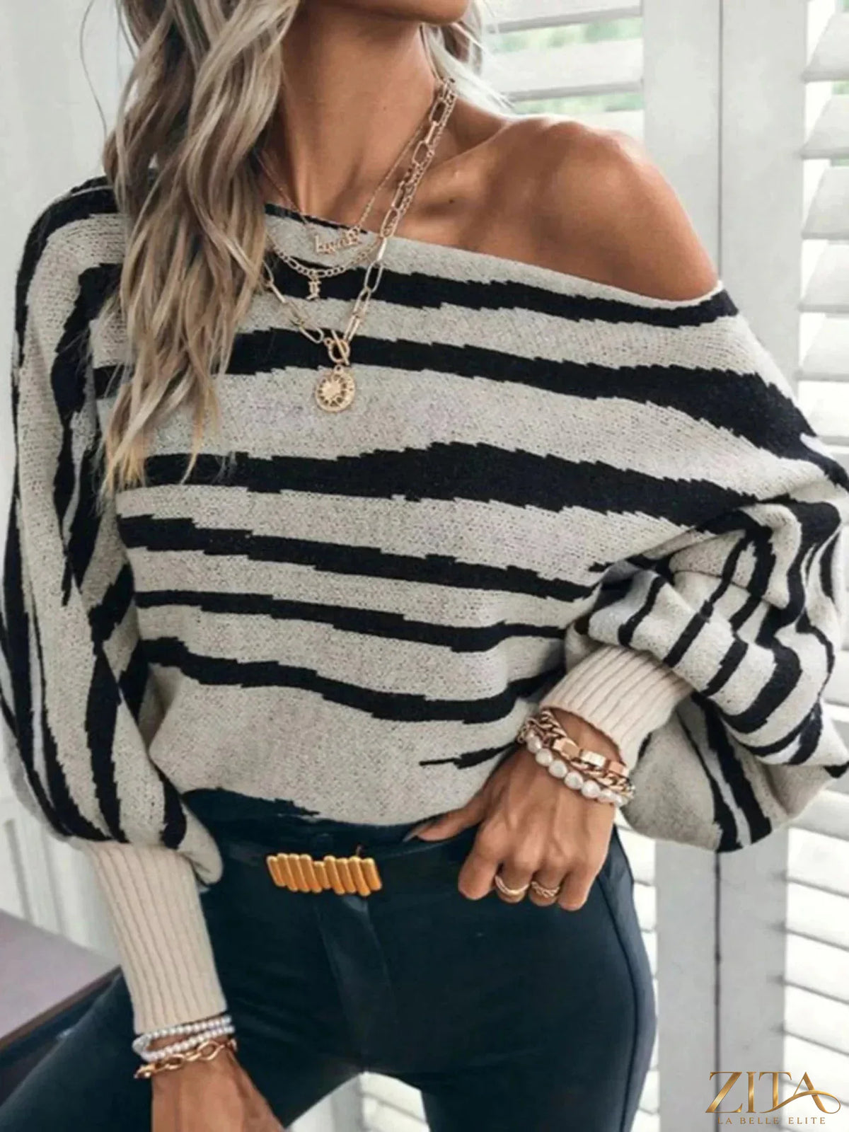 Striped lantern sleeve sweater by Trendsi featuring bold horizontal stripes and a relaxed fit, displayed on a neutral background.