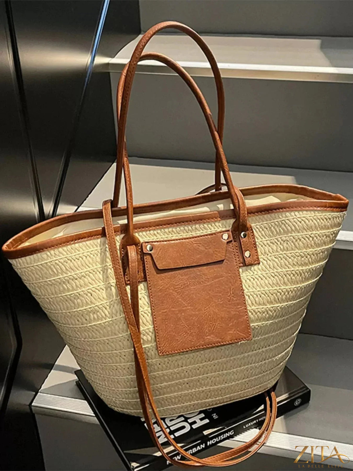 Zita La Belle Elite woven straw tote bag with leather handles and open top, suitable for casual outings or beach trips.
