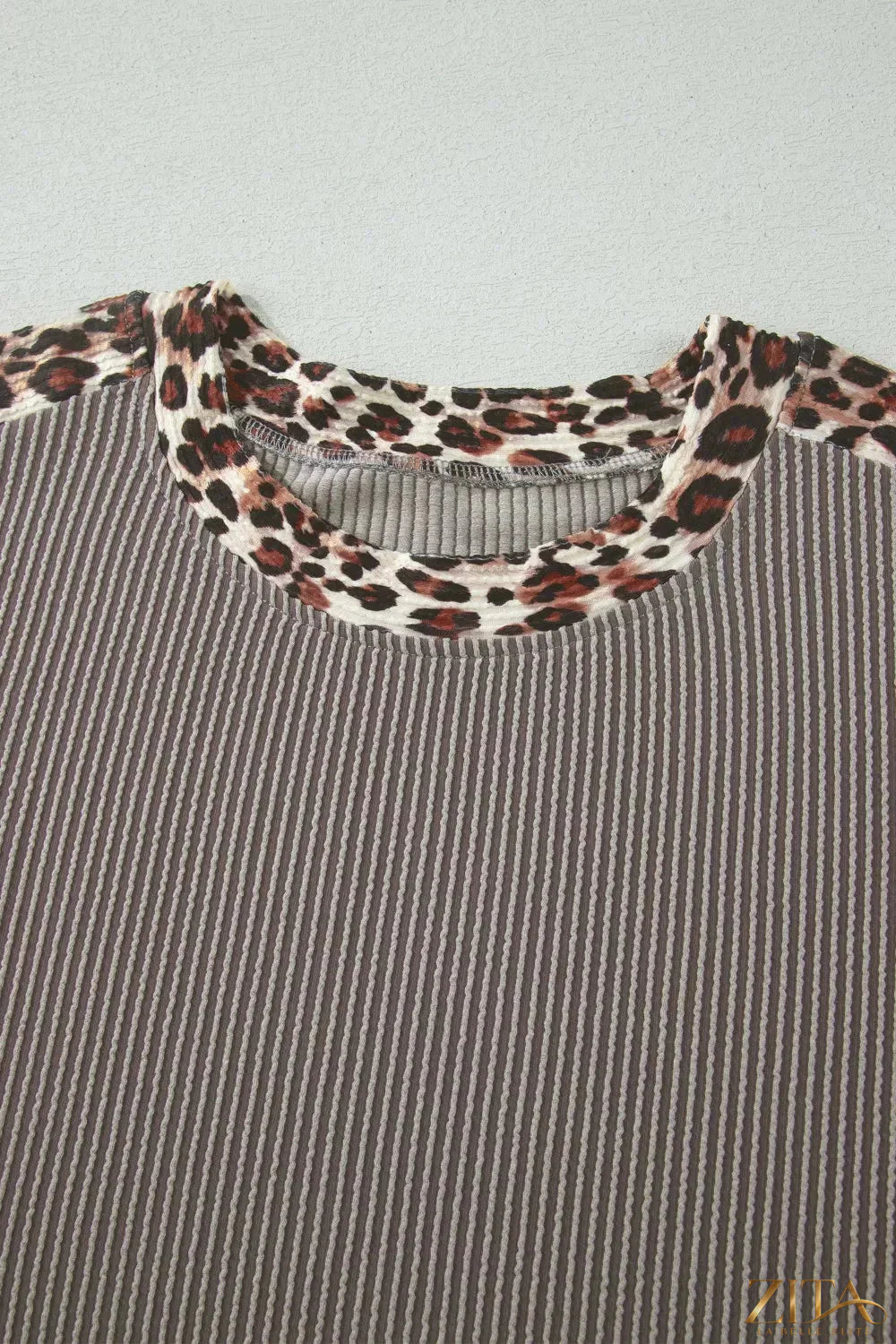 Leopard trim ribbed knit two-piece set by Trendsi, featuring a fitted tee and matching shorts with animal print accents.
