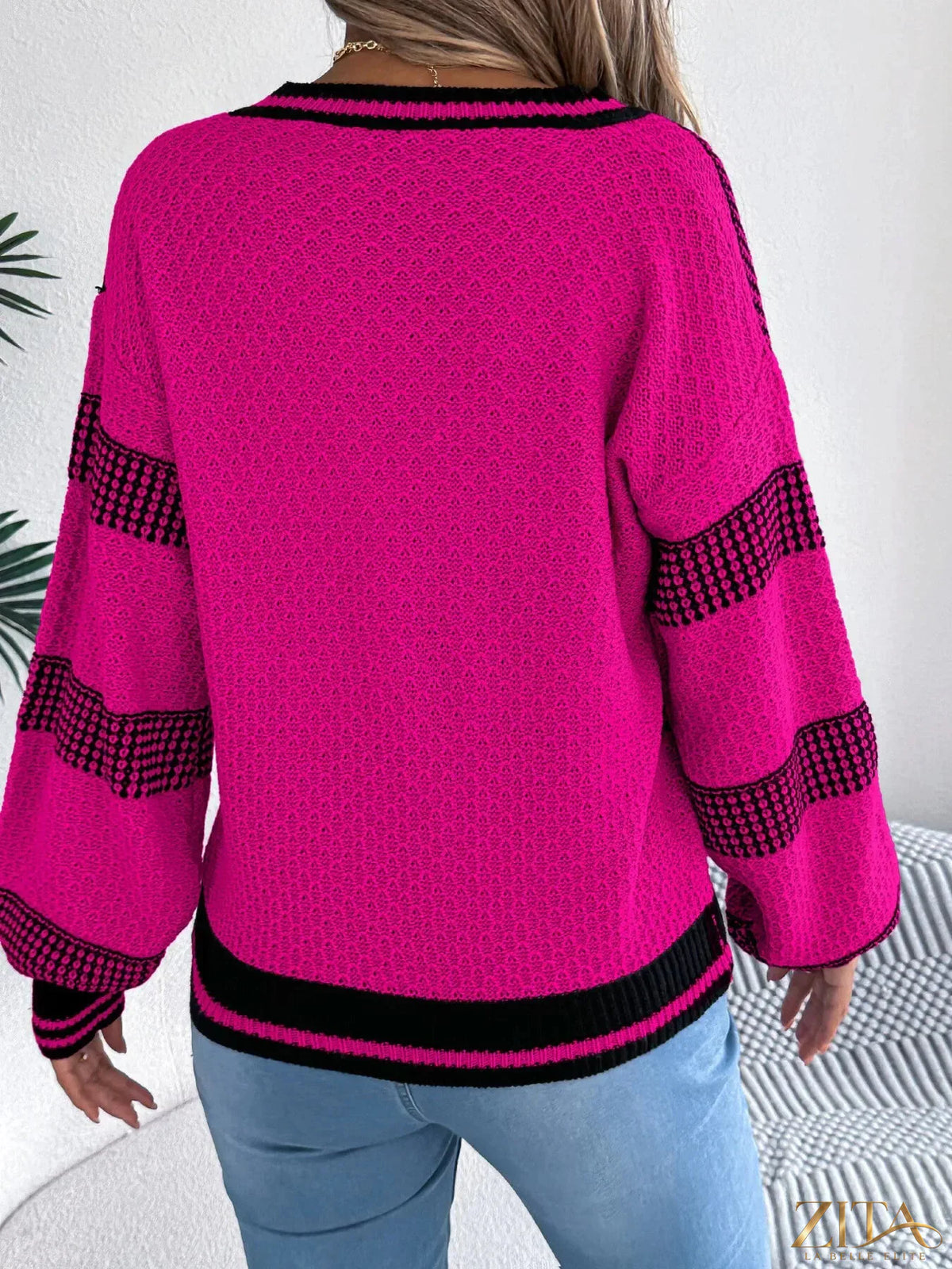 Contrast striped V-neck sweater by Trendsi featuring a cozy knit fabric and a stylish V-neck design.