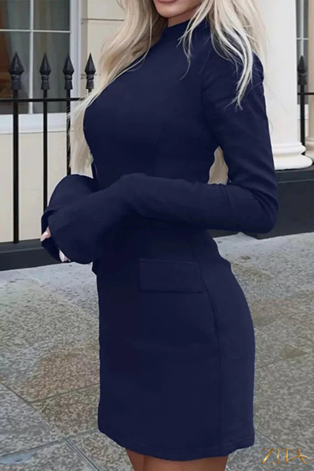 Long-sleeve mini dress with flap pockets by Trendsi, featuring a fitted silhouette and stylish pocket details.