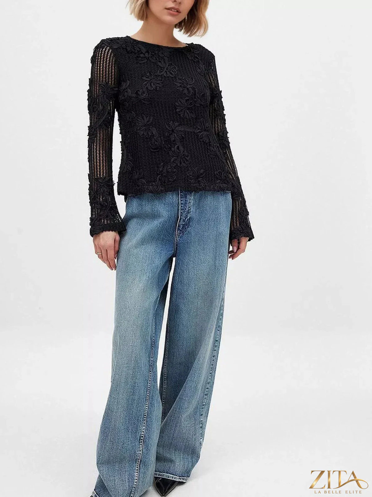 Openwork tied-back long sleeve blouse by Trendsi featuring a stylish design with openwork details and a back tie.