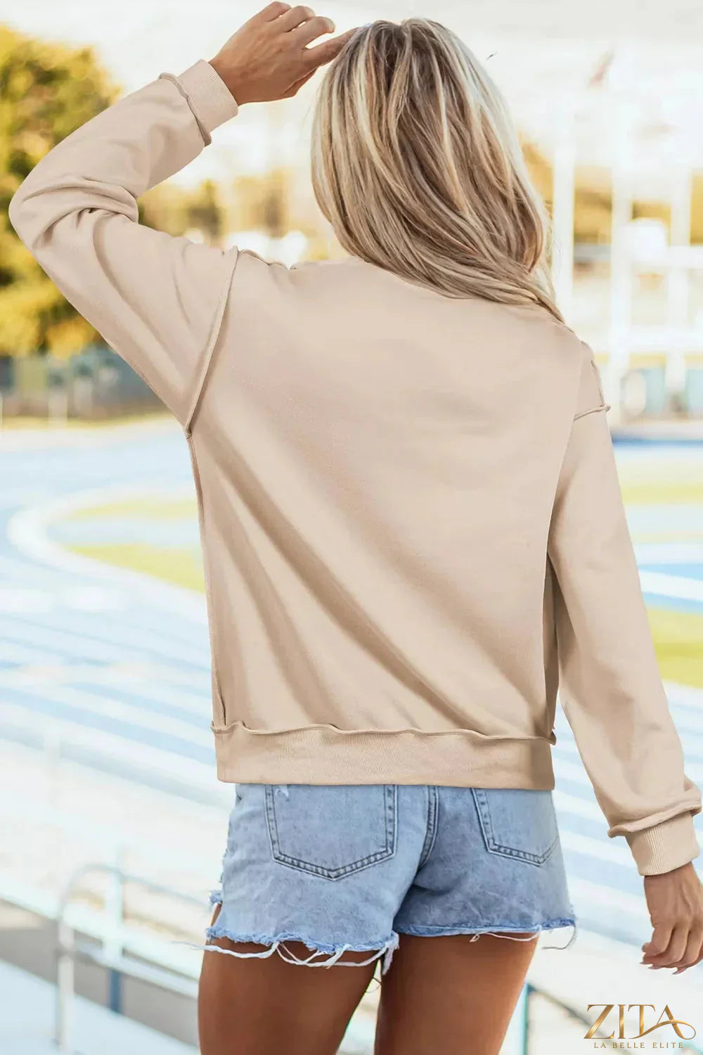 Thankful sequin mock neck sweatshirt by Zita La Belle Elite with shimmering sequins and cozy fit, shown on a hanger.