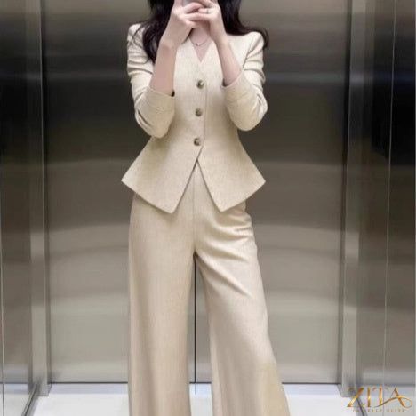 Zita La Belle Elite beige coat and wide-leg pants set, featuring a stylish waist-grabbing design and tailored coat with matching trousers.