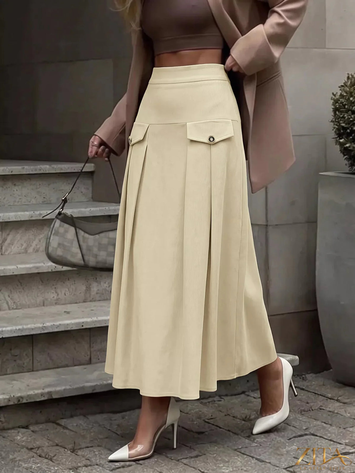 Zita La Belle Elite high waist pleated midi skirt in flowing fabric, styled with a modern and elegant look.