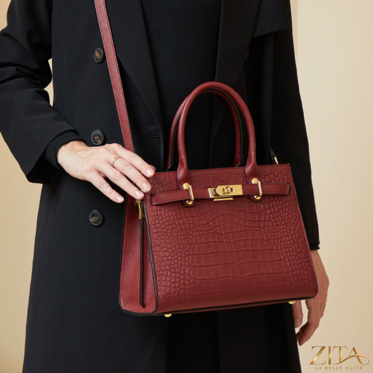 Crocodile-embossed leather top handle handbag by Zita La Belle Elite with gold hardware and structured design.