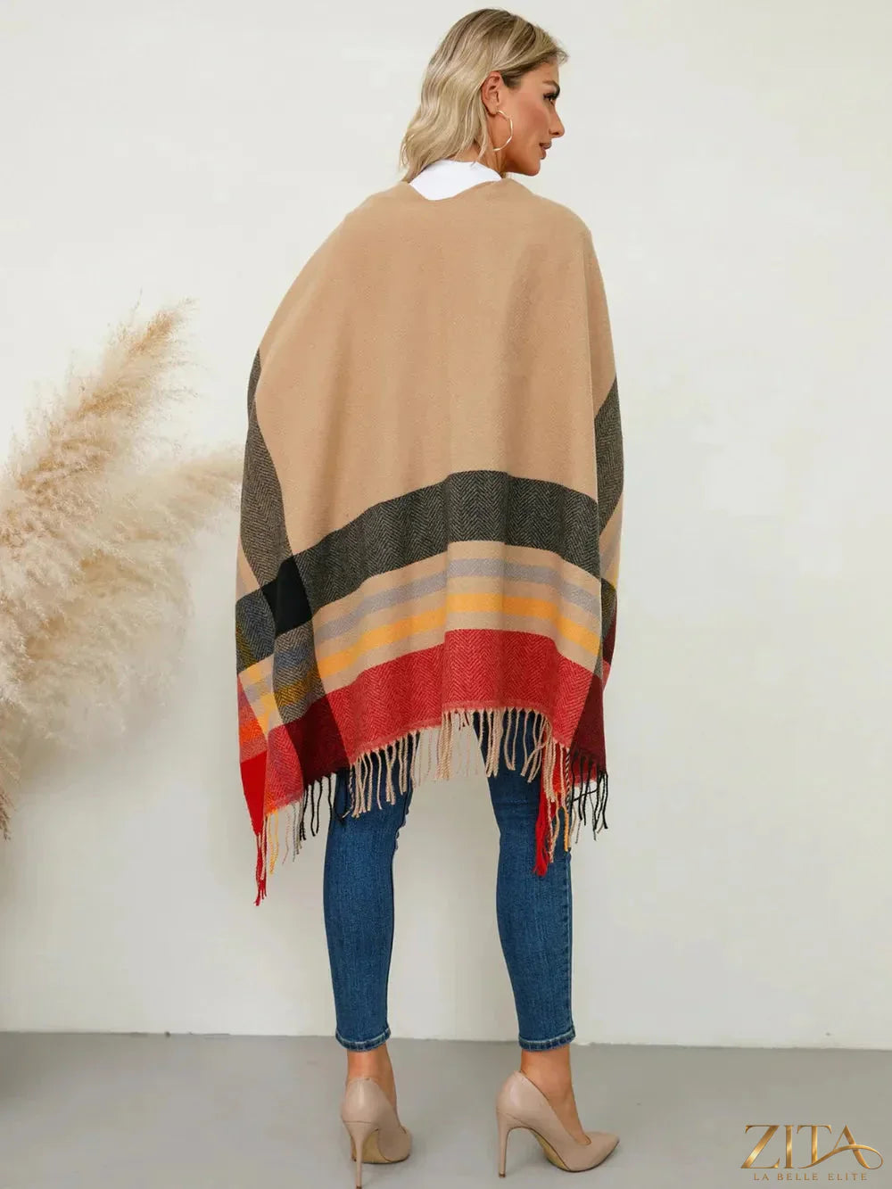 Trendsi fringe contrast plaid poncho with tassel details, showcasing a cozy, stylish accessory in a classic plaid pattern.