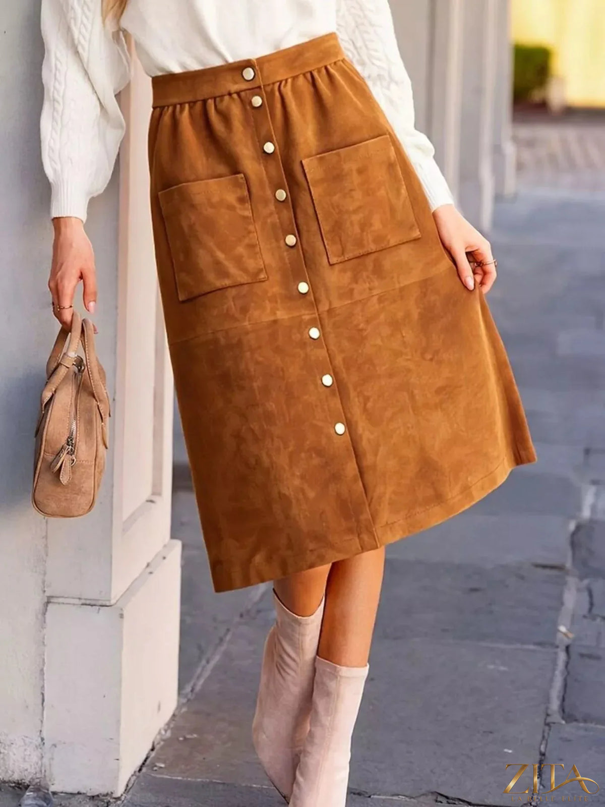 Button-front midi skirt by Trendsi, featuring a flowy fabric, high waist, and stylish button details, perfect for casual or dressy wear.