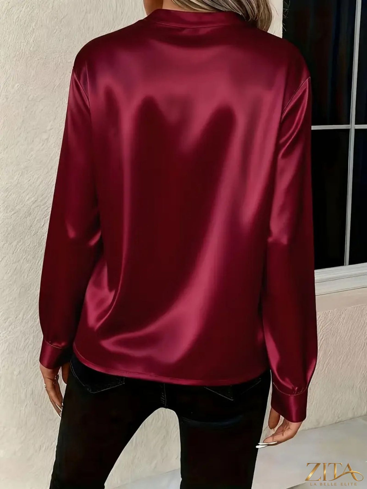Zita La Belle Elite satin notched long sleeve blouse displayed on a hanger with a V-neck and elegant design.