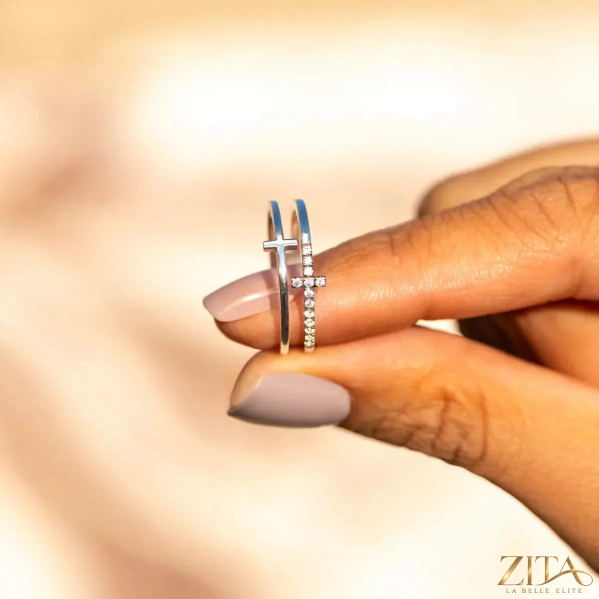 Zita La Belle Elite double band cross ring featuring intertwined silver bands and a cross design in a close-up shot