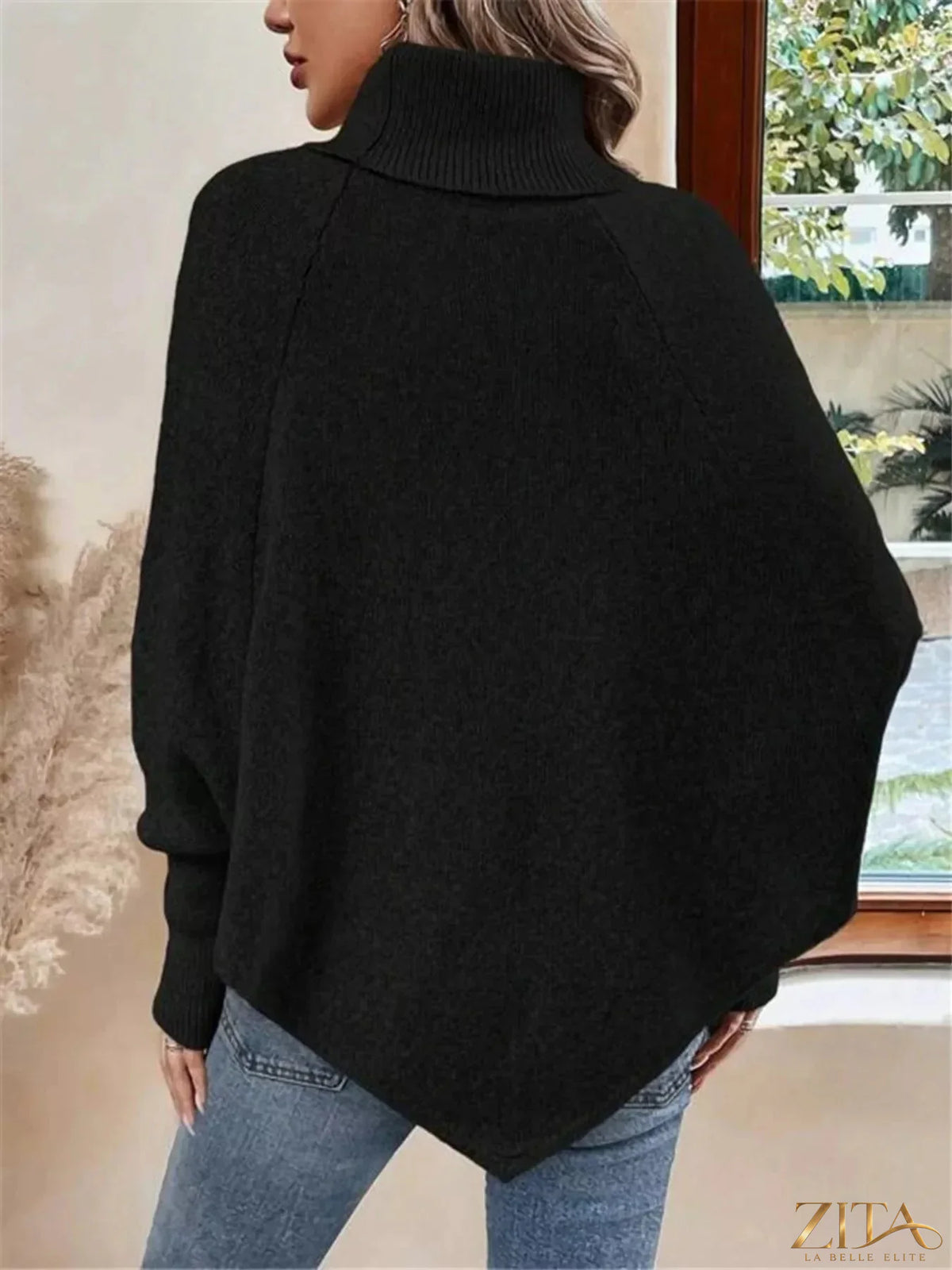 Cable knit turtleneck cape sweater by Trendsi featuring a cozy, textured knit design and a stylish turtleneck collar.