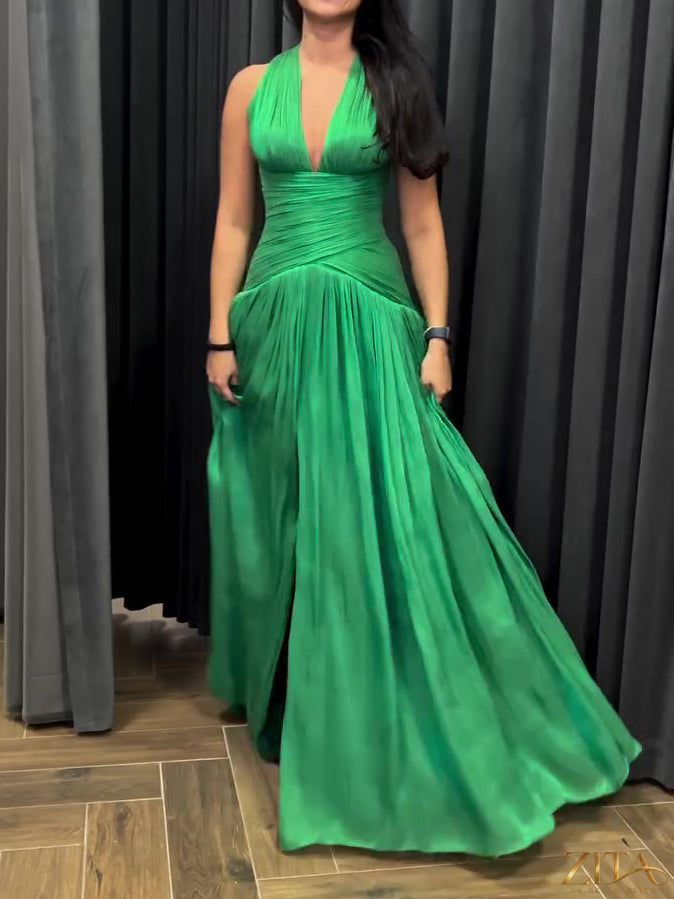 Emerald green Zita La Belle Elite dress with plunging neckline, pleated skirt, and side slit, styled for elegant occasions.