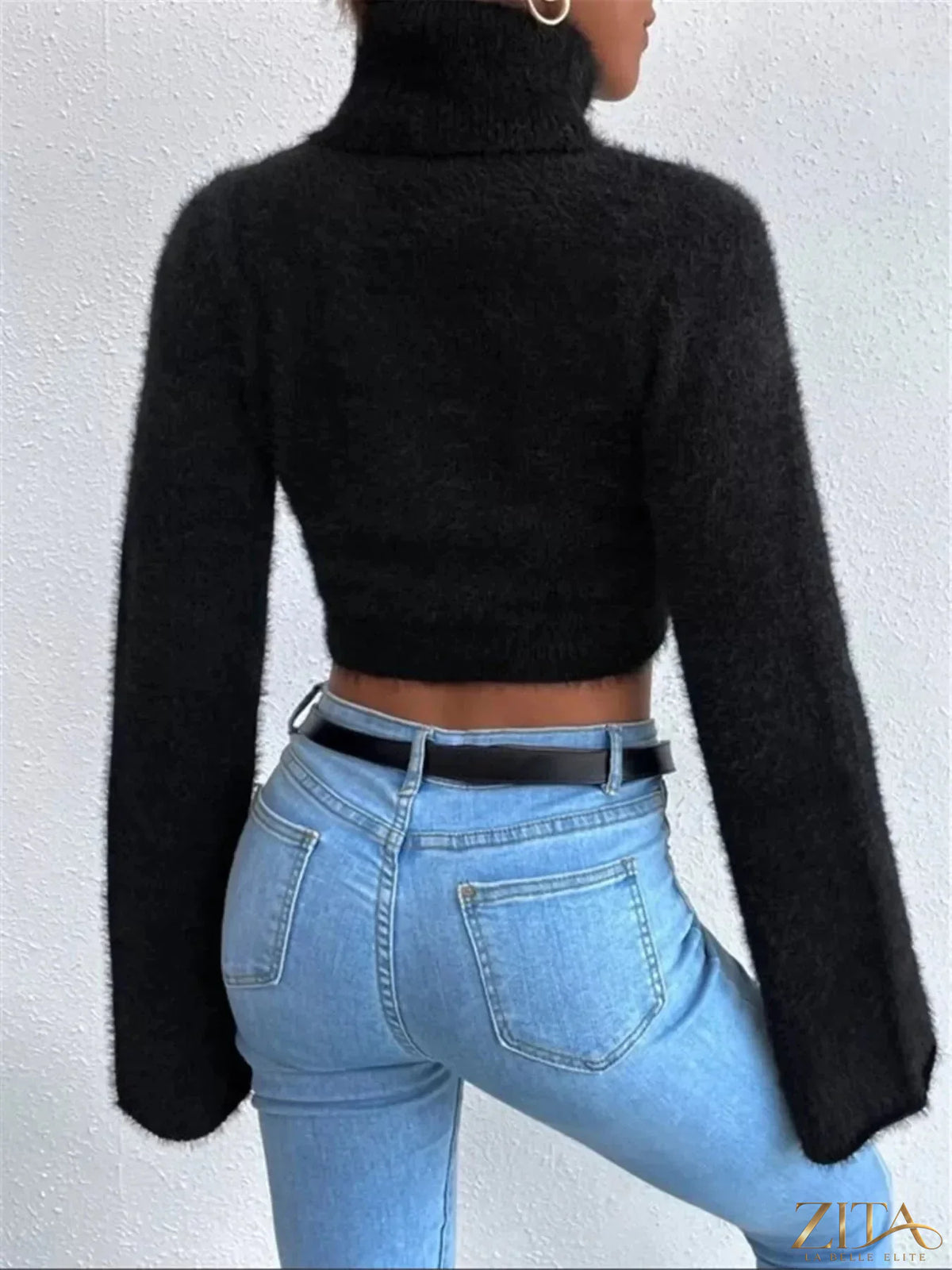 Cream turtleneck sweater with flare sleeves from Trendsi, showcasing a cozy knit design and stylish silhouette.