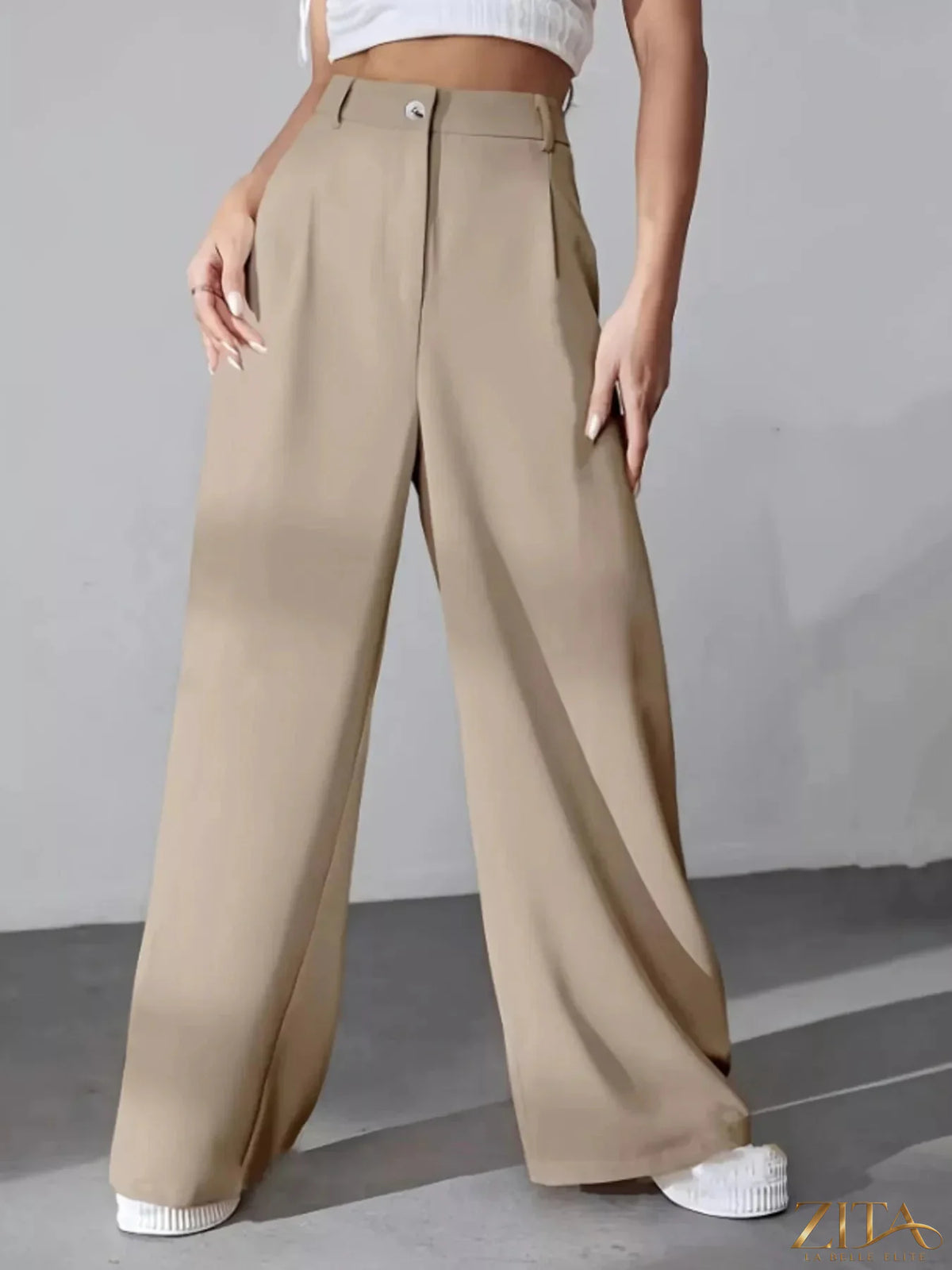 Zita La Belle Elite wide leg pleated pants in neutral fabric, showing their flowy, high-waisted design and relaxed fit.