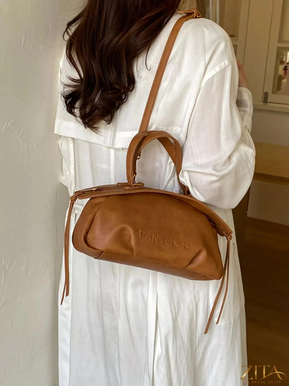 Trendsi PU leather crossbody bag with adjustable strap, featuring sleek design and spacious interior for everyday use.