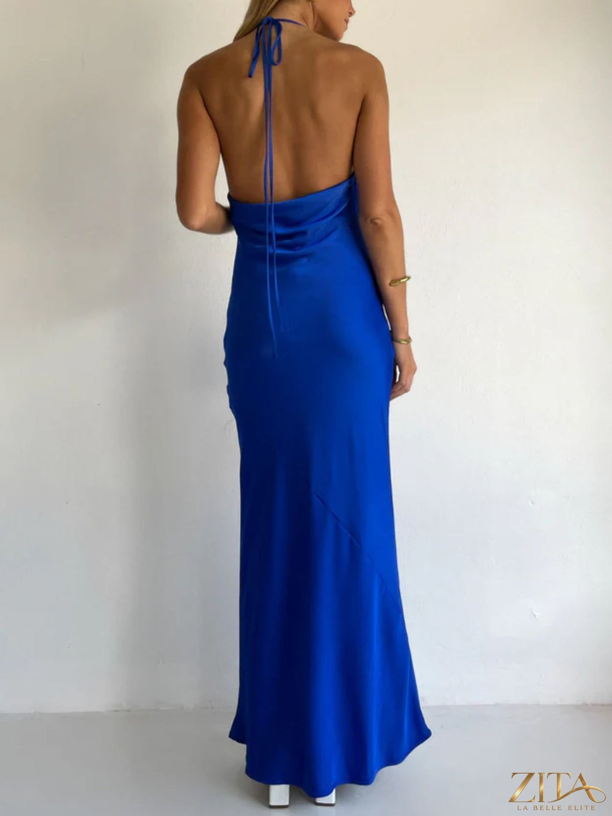 Zita La Belle Elite halter neck satin maxi dress displayed on a hanger with flowing fabric and elegant design.