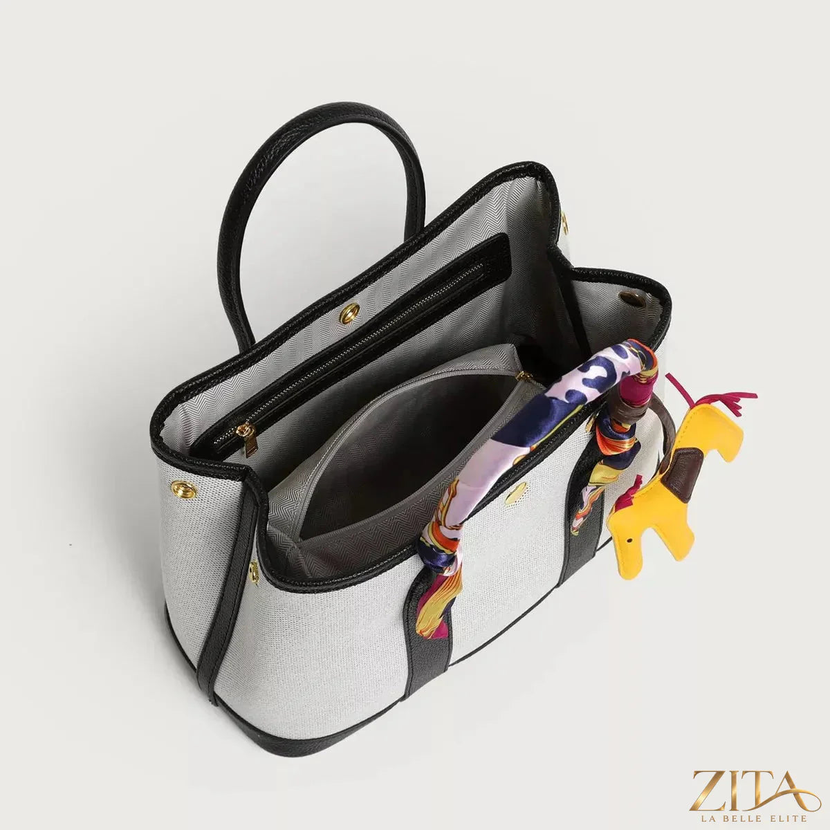 Zita La Belle Elite canvas handbag with silk scarf and horse charm, showcasing elegant accessories and stylish design.