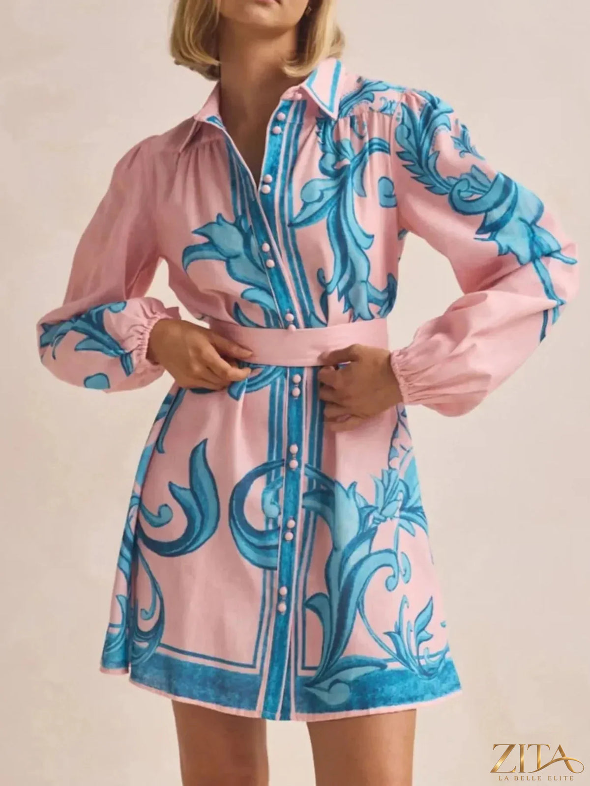 Printed long sleeve shirt dress by Trendsi featuring a stylish, lightweight fabric with a relaxed fit and button-front design.