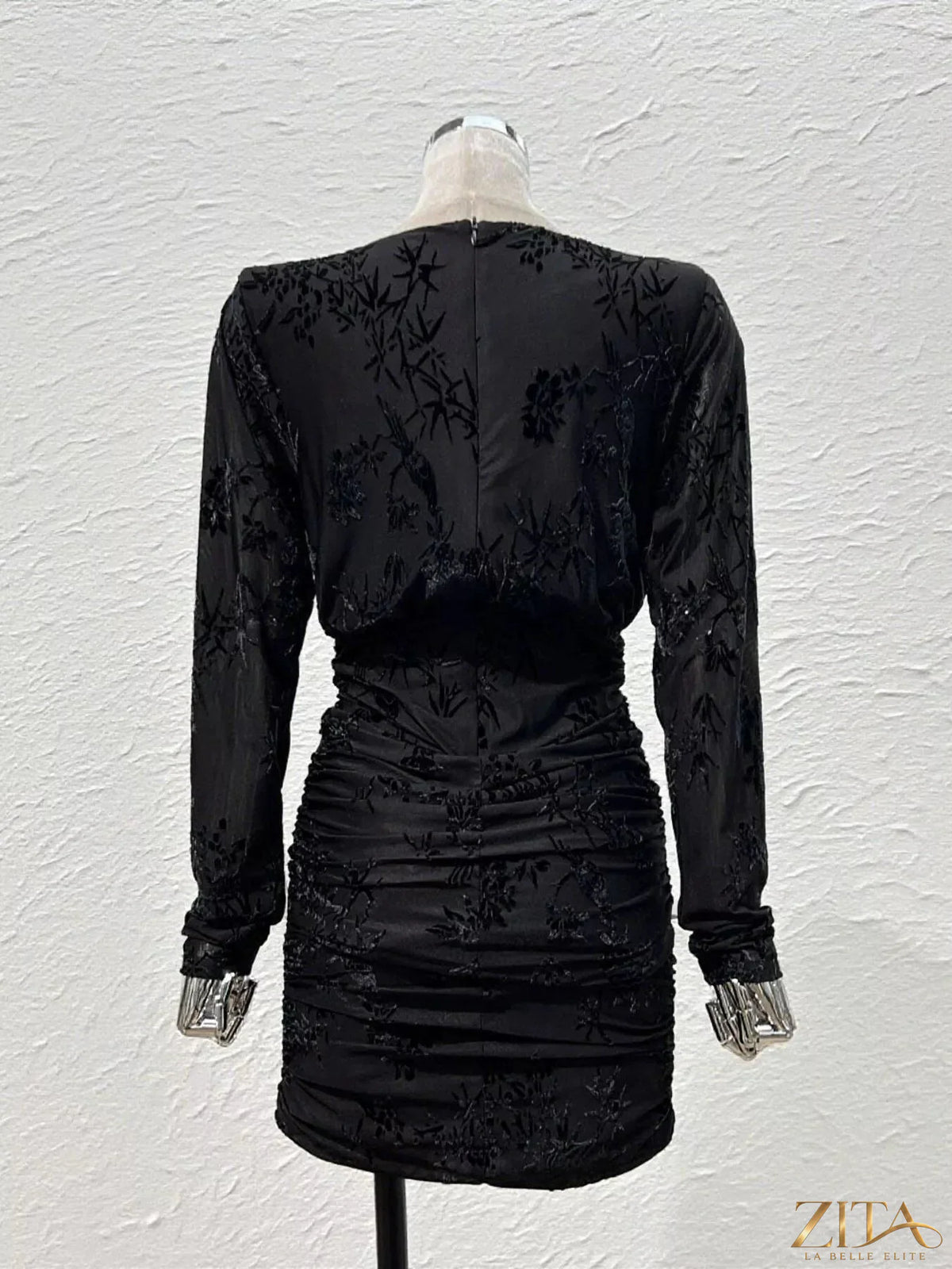 Ruched long sleeve mini dress by Trendsi, featuring a fitted silhouette with gathered fabric and a stylish, chic design.