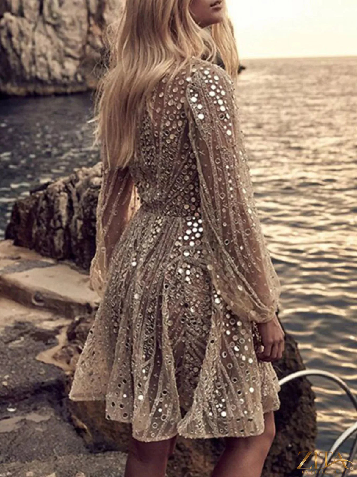Zita La Belle Elite sequin deep V-neck mini dress with shimmering embellishments and fitted silhouette on model.