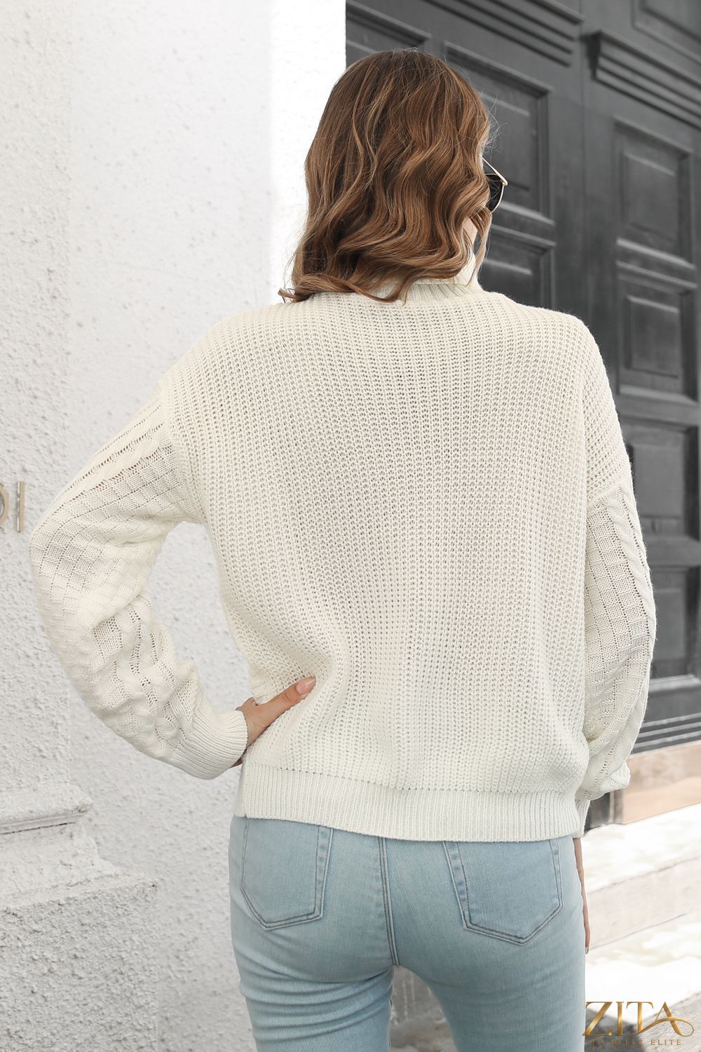 Zita La Belle Elite cable-knit turtleneck sweater in cozy, textured knit fabric, worn by a model featuring a high turtleneck collar.
