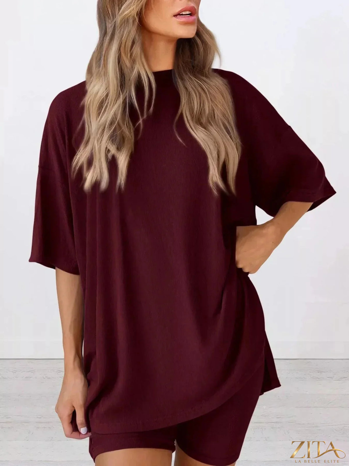 Plus size relaxed fit top and shorts two-piece set by Trendsi, featuring comfortable casual style and soft fabric.