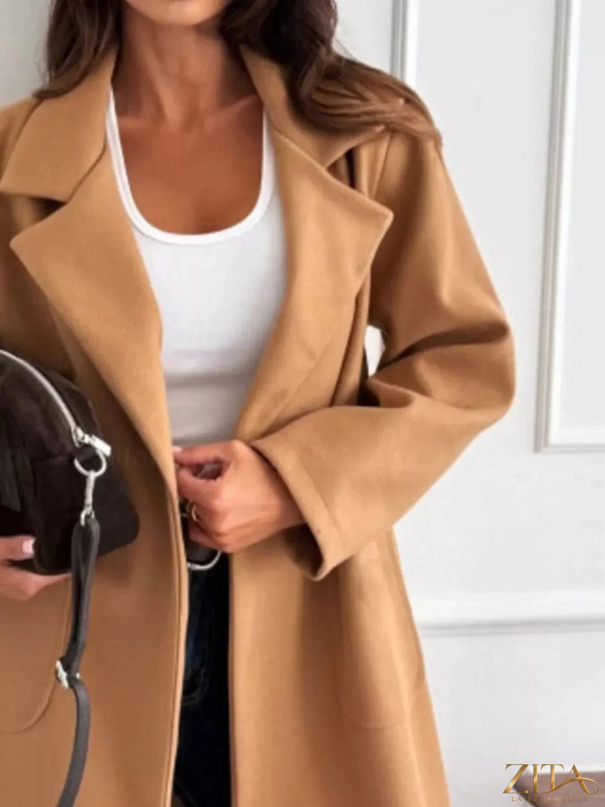 Zita La Belle Elite long-sleeve single-breasted trench coat in classic beige, shown hanging on a wooden hanger.