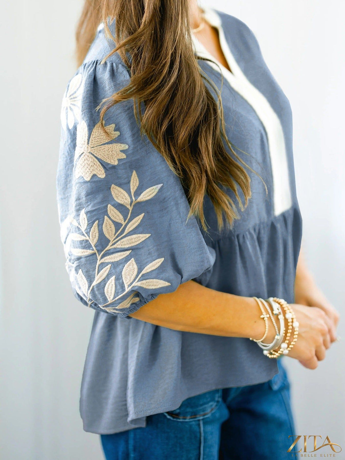 Zita La Belle Elite embroidered sleeve peplum blouse with intricate detailing and a flattering fit, shown on a mannequin.