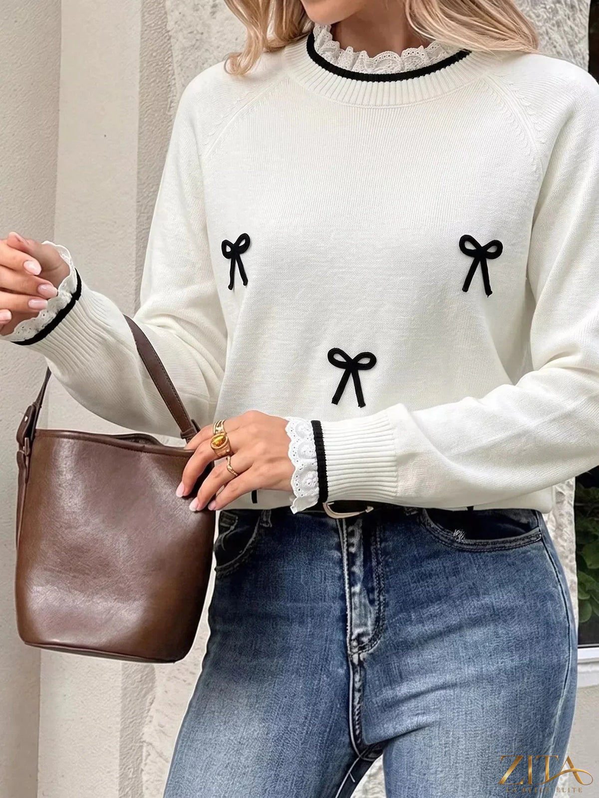 Zita La Belle Elite lace-trimmed sweater with bow embellishments, featuring delicate lace details and a cozy knit design.