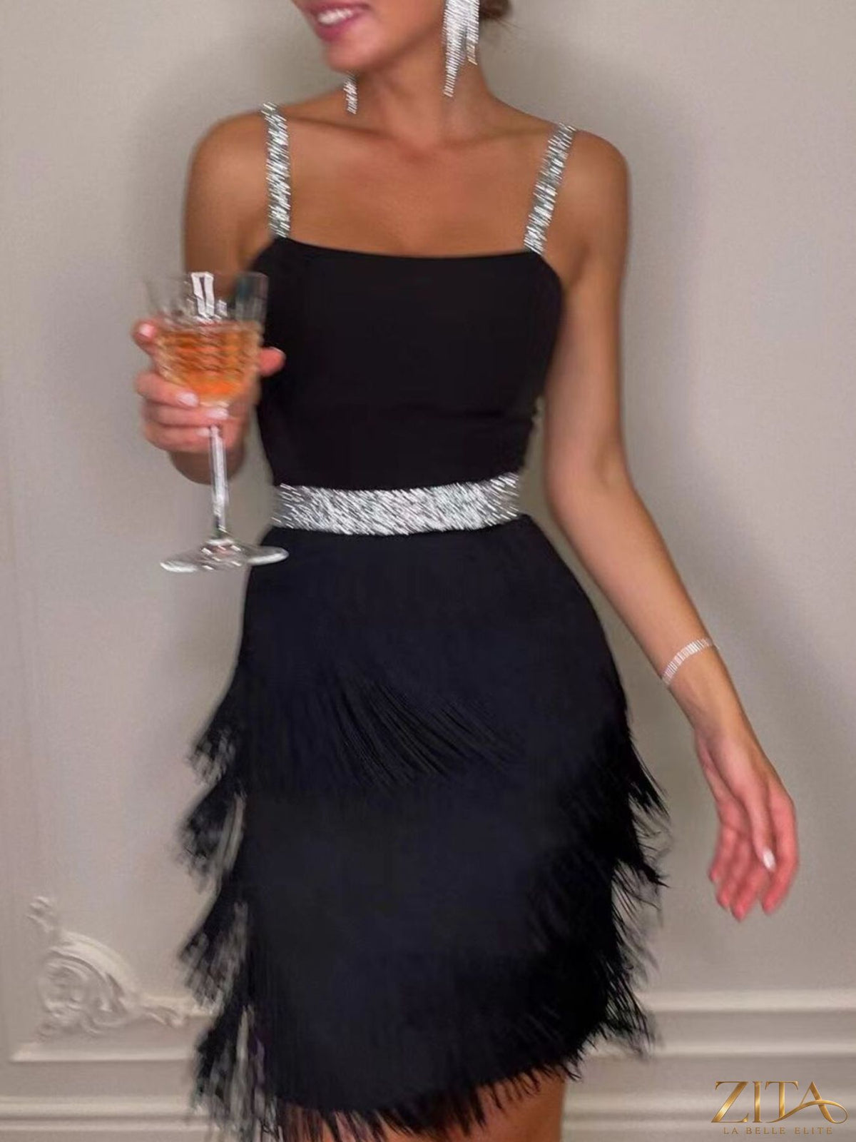 Trendsi fringe trim cami mini dress with a flowy silhouette and decorative fringe details, shown on a model.