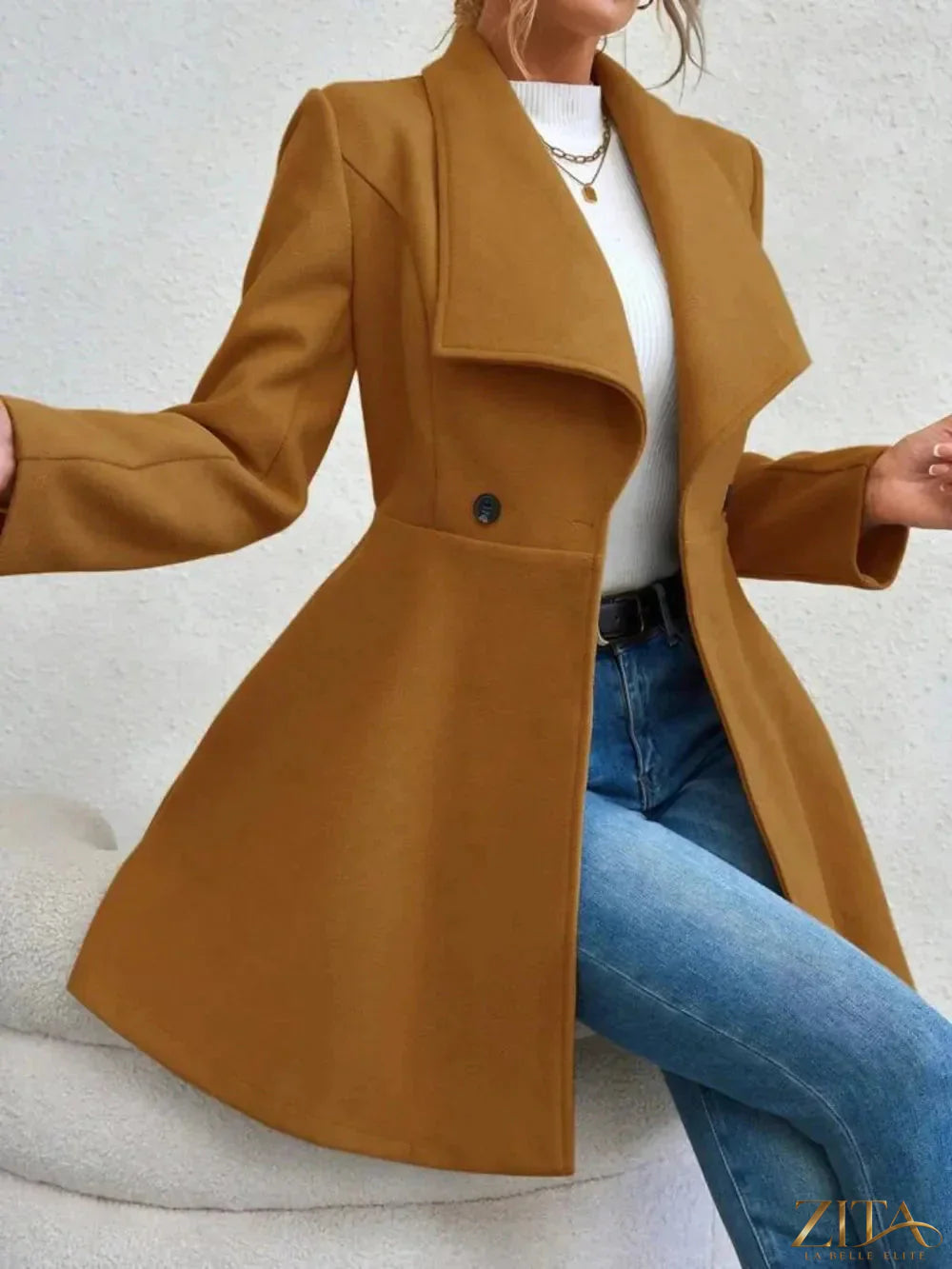 Zita La Belle Elite collared neck button-up long sleeve coat hanging on a hanger, showcasing a stylish, tailored outerwear piece.