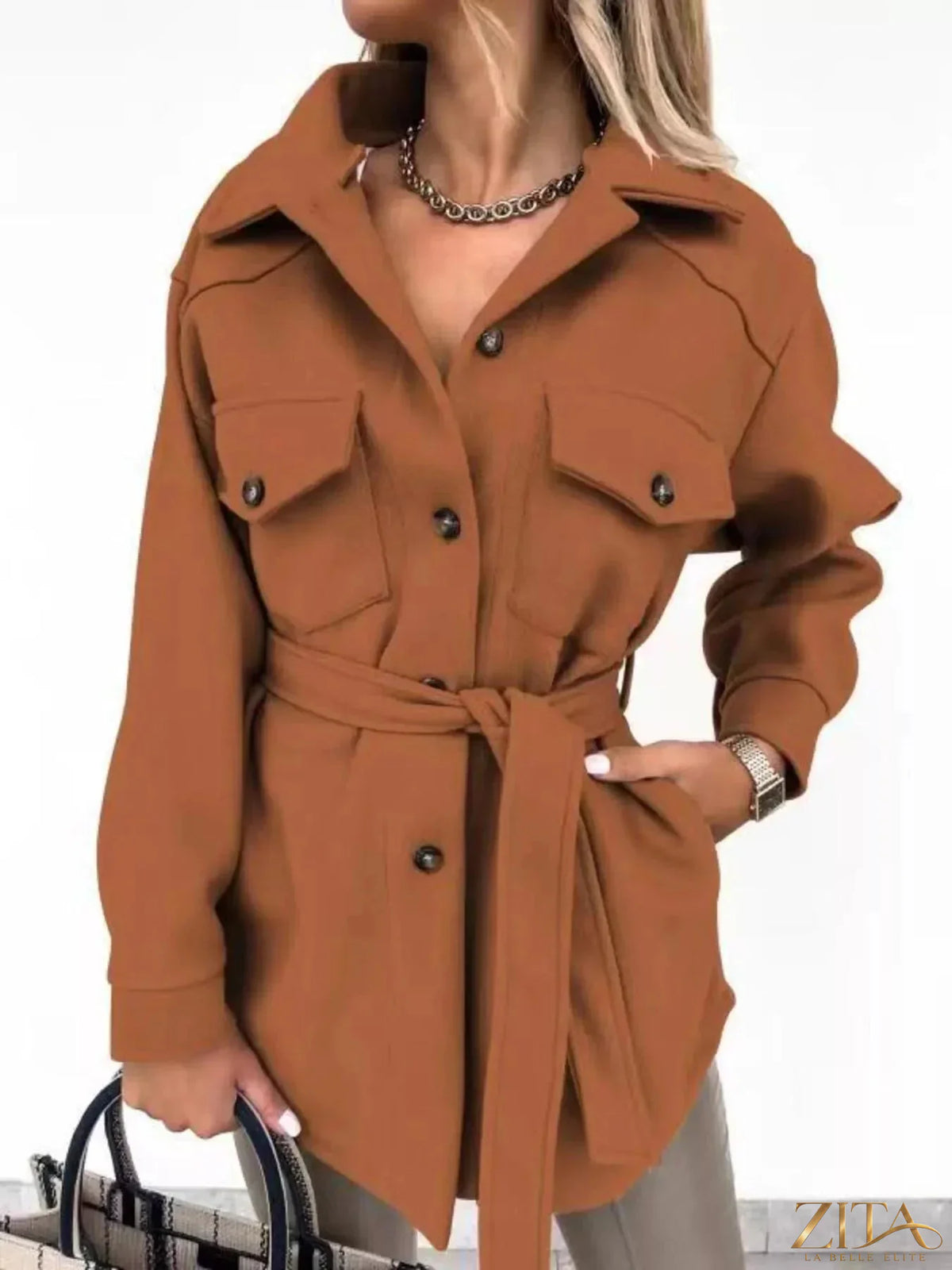Zita La Belle Elite button-down tie waist coat in neutral fabric, displayed hanging on a wooden hanger.