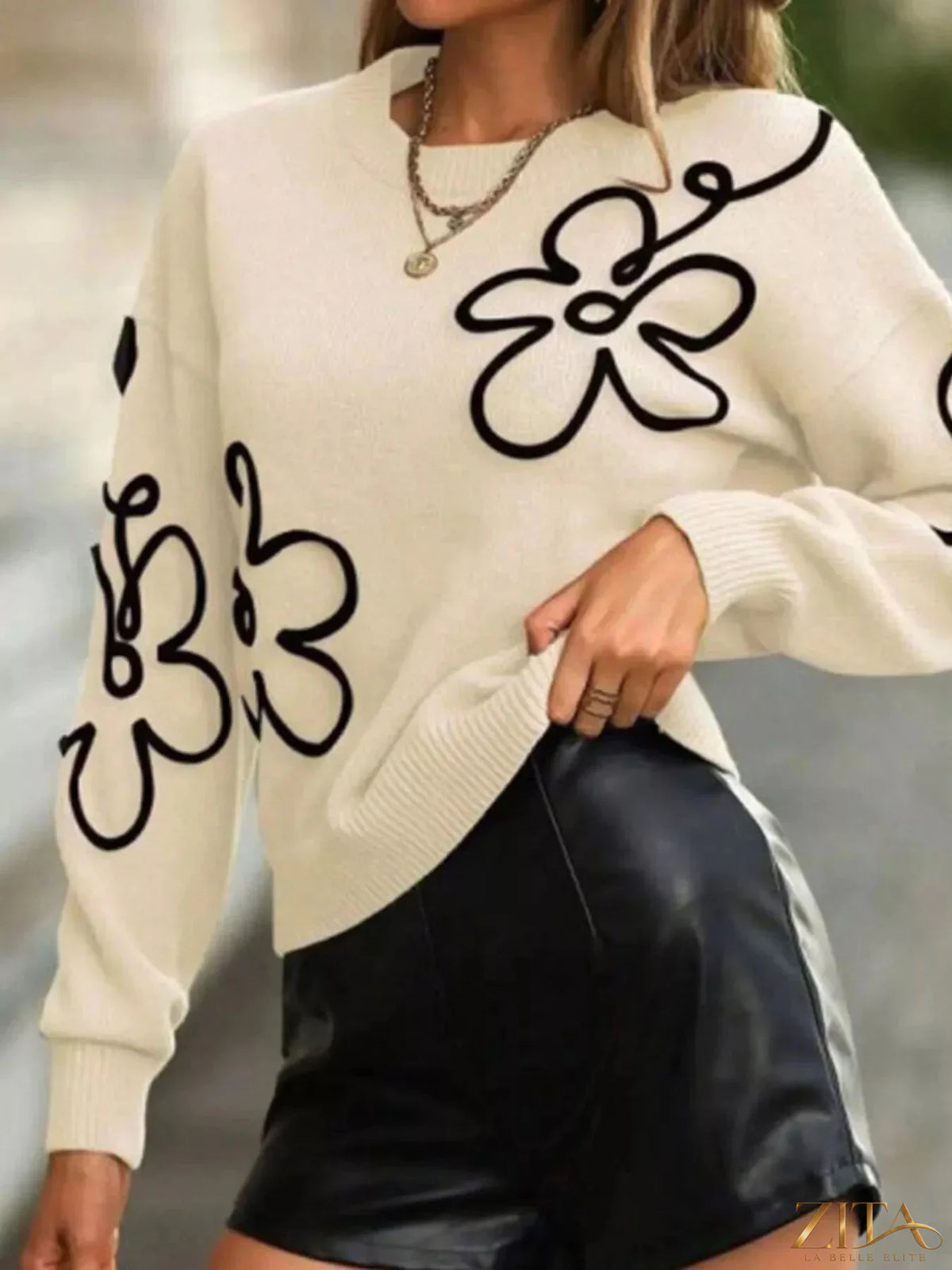 Flower dropped shoulder sweater by Trendsi, featuring soft fabric, floral accents, and a relaxed fit with dropped shoulder design.