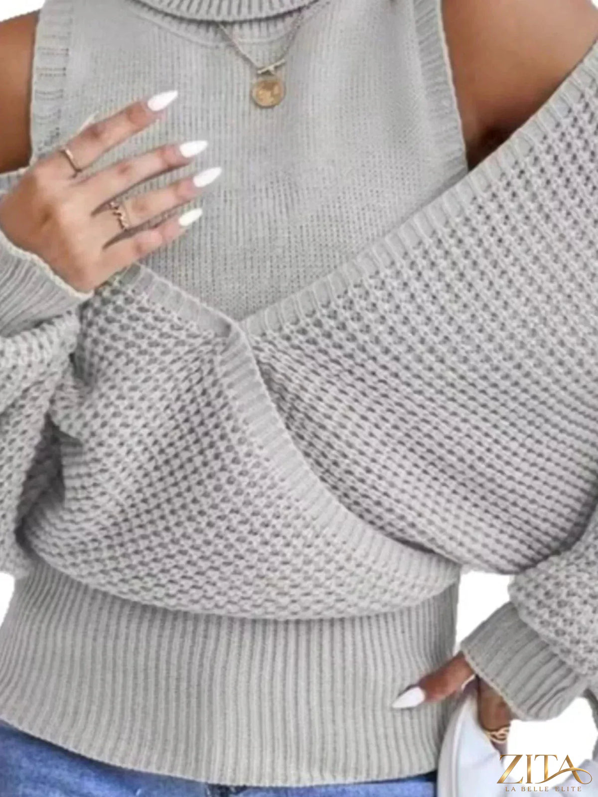 Waffle knit cold shoulder turtleneck sweater by Trendsi featuring long sleeves and a cozy, textured fabric in a neutral color.