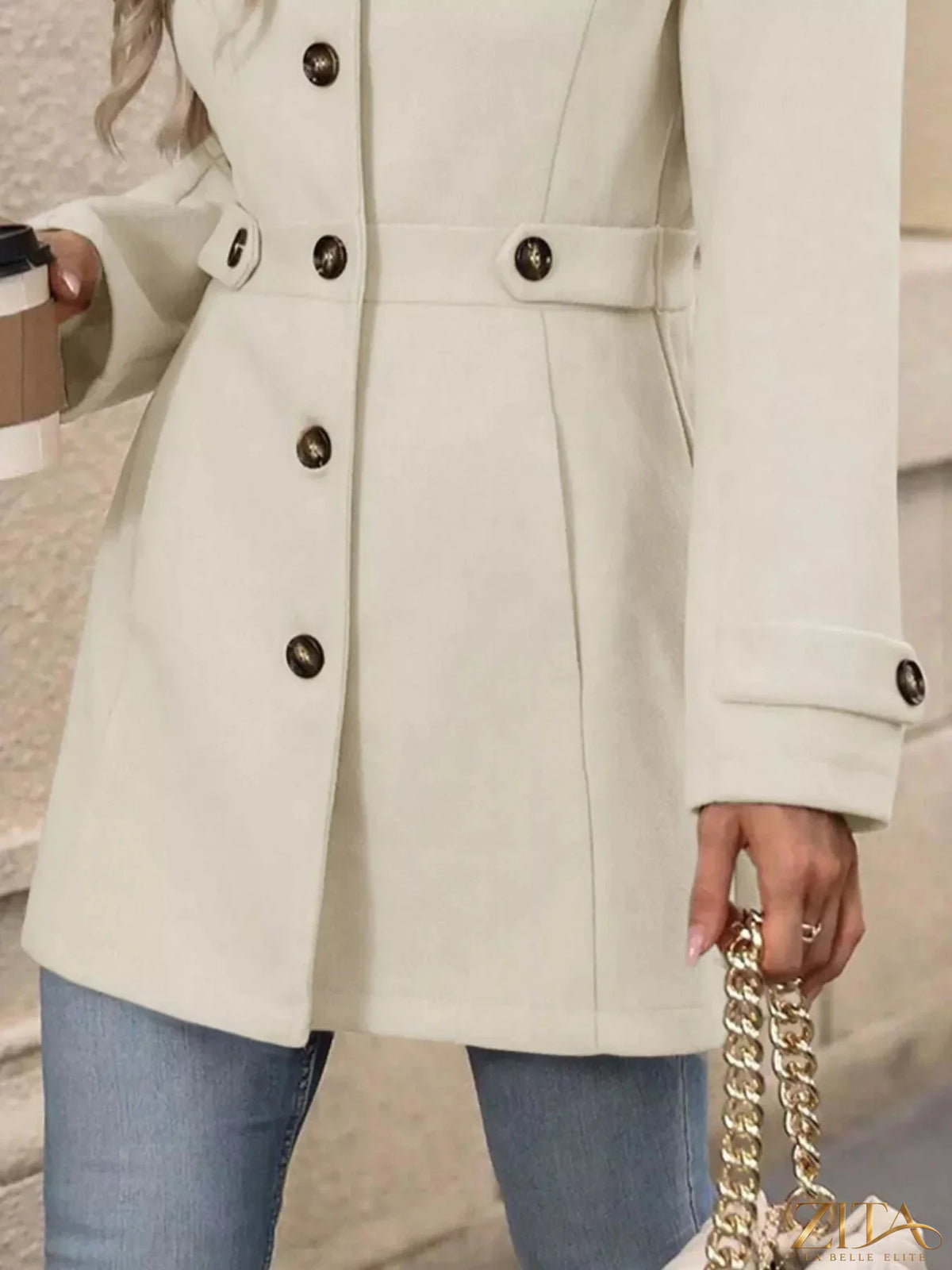 Zita La Belle Elite button-up long sleeve coat in neutral fabric, featuring a classic collar and tailored fit, displayed on a hanger.
