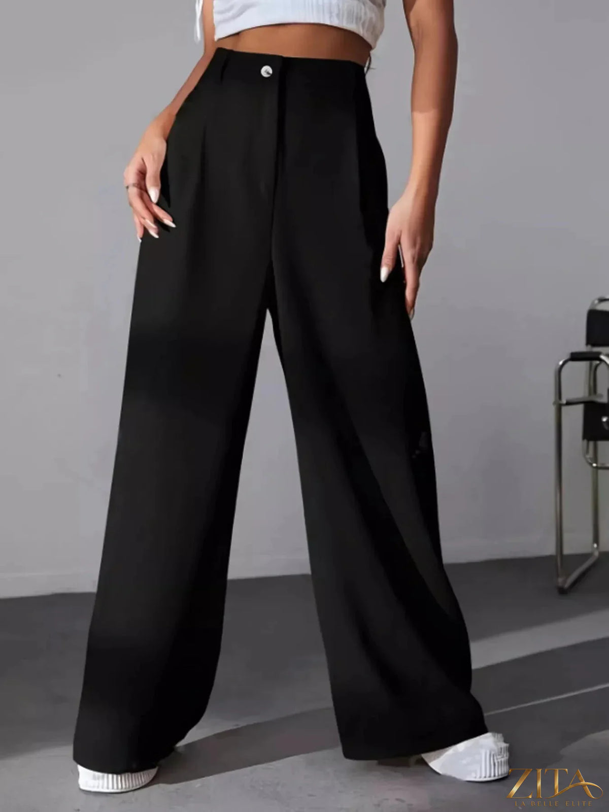 Zita La Belle Elite wide leg pleated pants in a flowing fabric, styled with a high waist and relaxed fit.