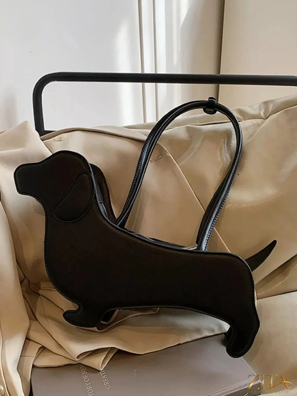 Zita La Belle Elite Dachshund-shaped shoulder bag in tan with black accents, featuring detailed dog design and adjustable strap.