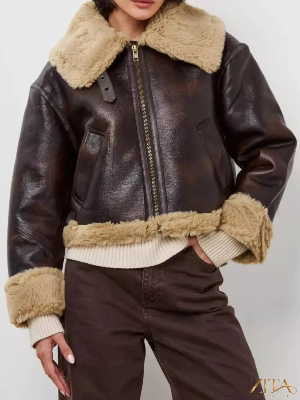 Vintage-inspired faux leather aviator jacket with plush shearling trim by Zita La Belle Elite, featuring classic aviator design and warm details.