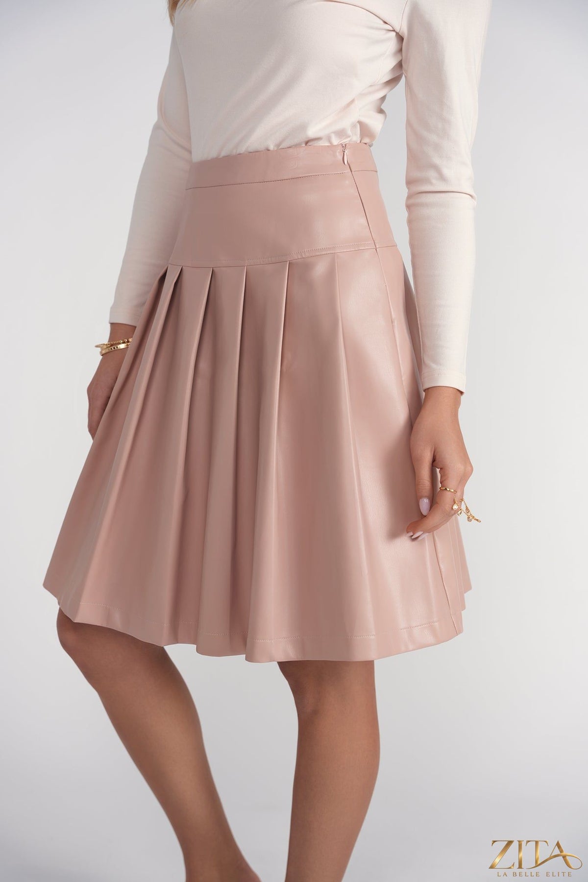 Pink drop waist leather pleated skirt by Zita La Belle Elite, featuring a stylish silhouette and detailed pleats.