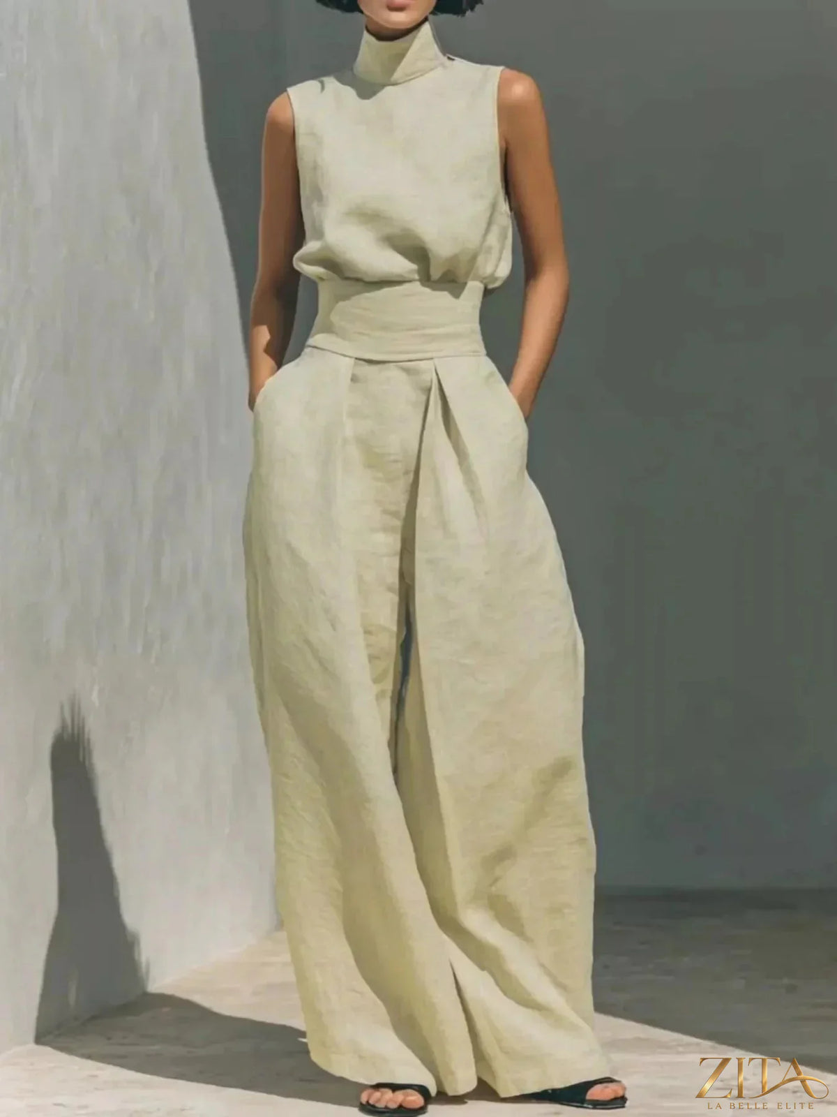 Sleeveless turtleneck top and wide-leg pants set by Trendsi, stylish casual outfit with neutral tones and relaxed fit.
