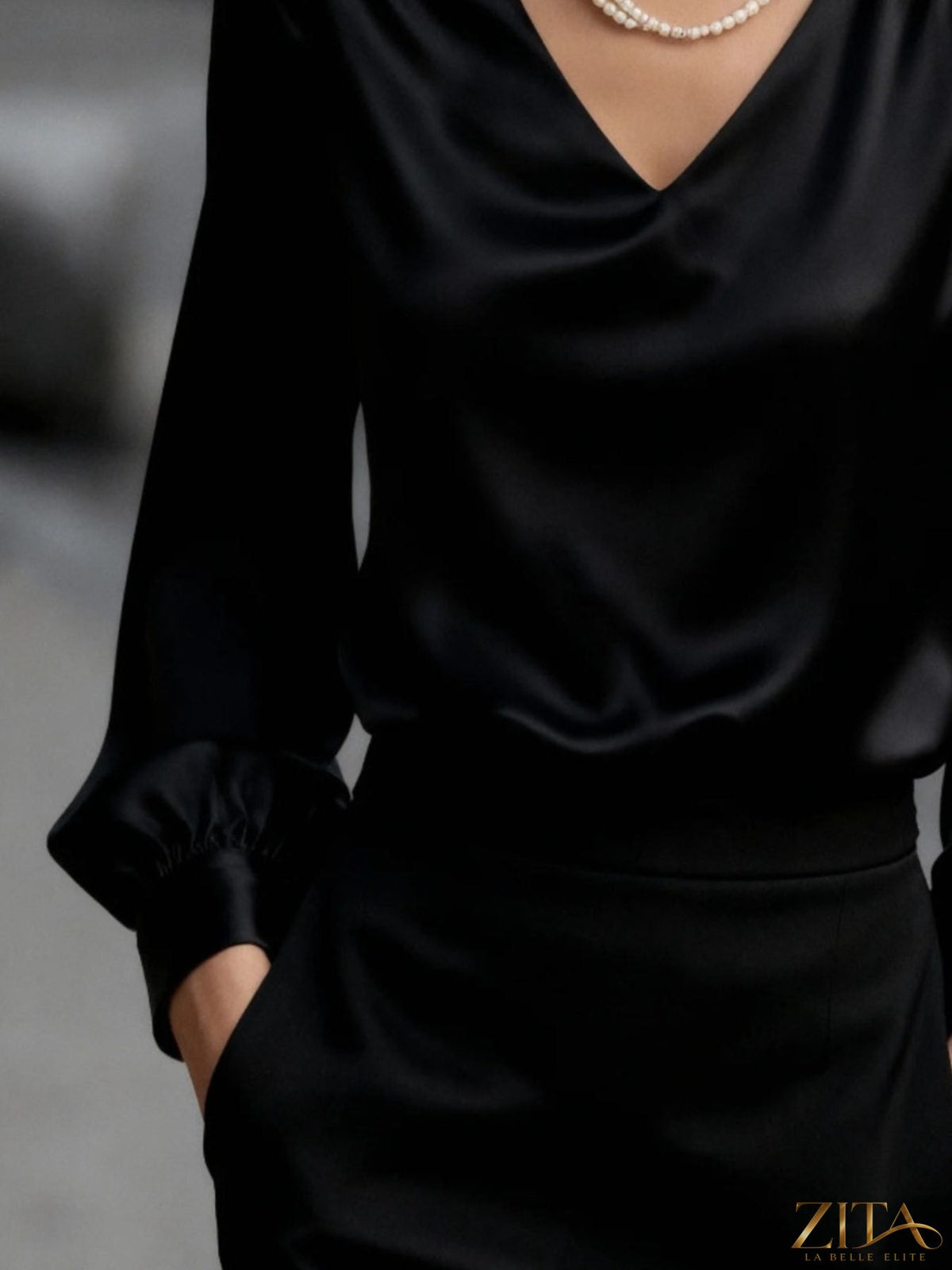 Zita La Belle Elite satin V-neck long sleeve blouse displayed on a hanger, showcasing smooth fabric and elegant design details.